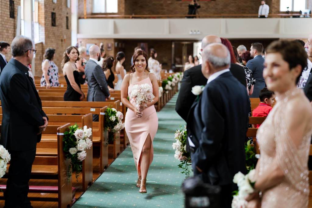 ST-PETER-CHANEL-CATHOLIC-CHURCH-BERALA-SYDNEY-WEDDING-PHOTOGRAPHER-ANELLOWEDDINGS-BRIDESMAID-WALKING0