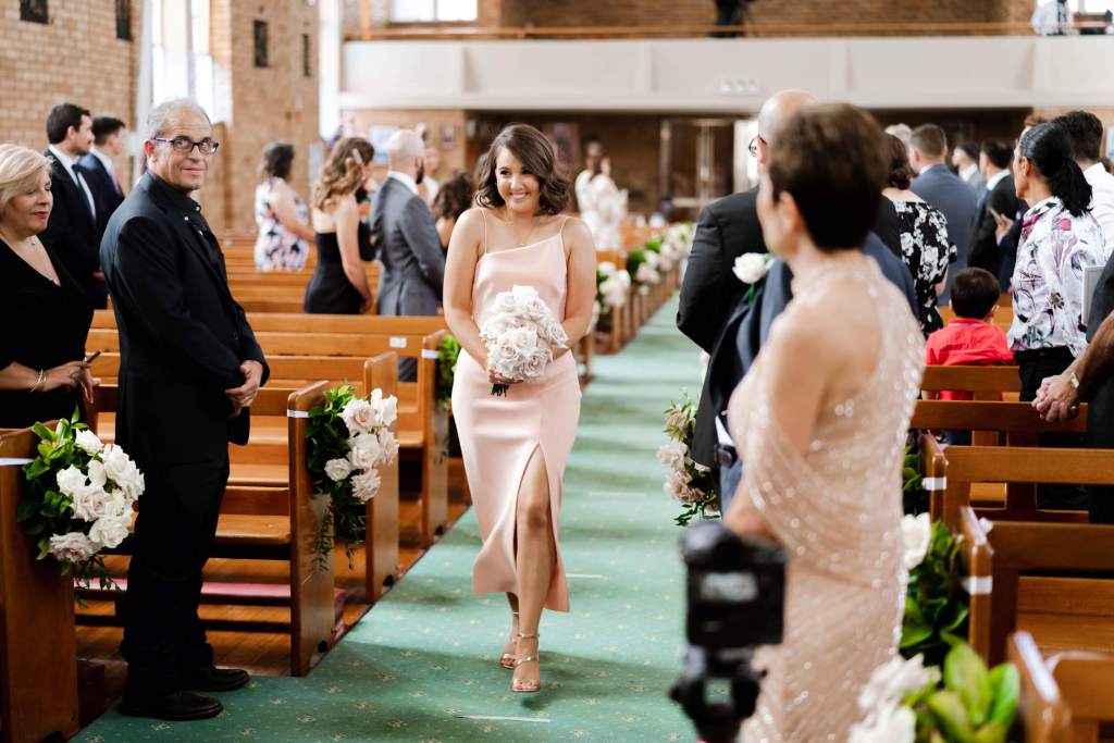 ST-PETER-CHANEL-CATHOLIC-CHURCH-BERALA-SYDNEY-WEDDING-PHOTOGRAPHER-ANELLOWEDDINGS-BRIDESMAID-WALKING