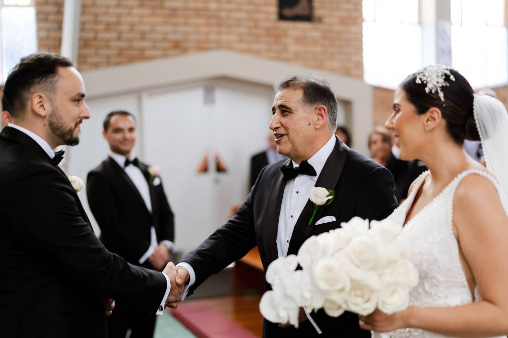 ST-PETER-CHANEL-CATHOLIC-CHURCH-BERALA-SYDNEY-WEDDING-PHOTOGRAPHER-ANELLOWEDDINGS-FATHER-GROOM-SHAKE