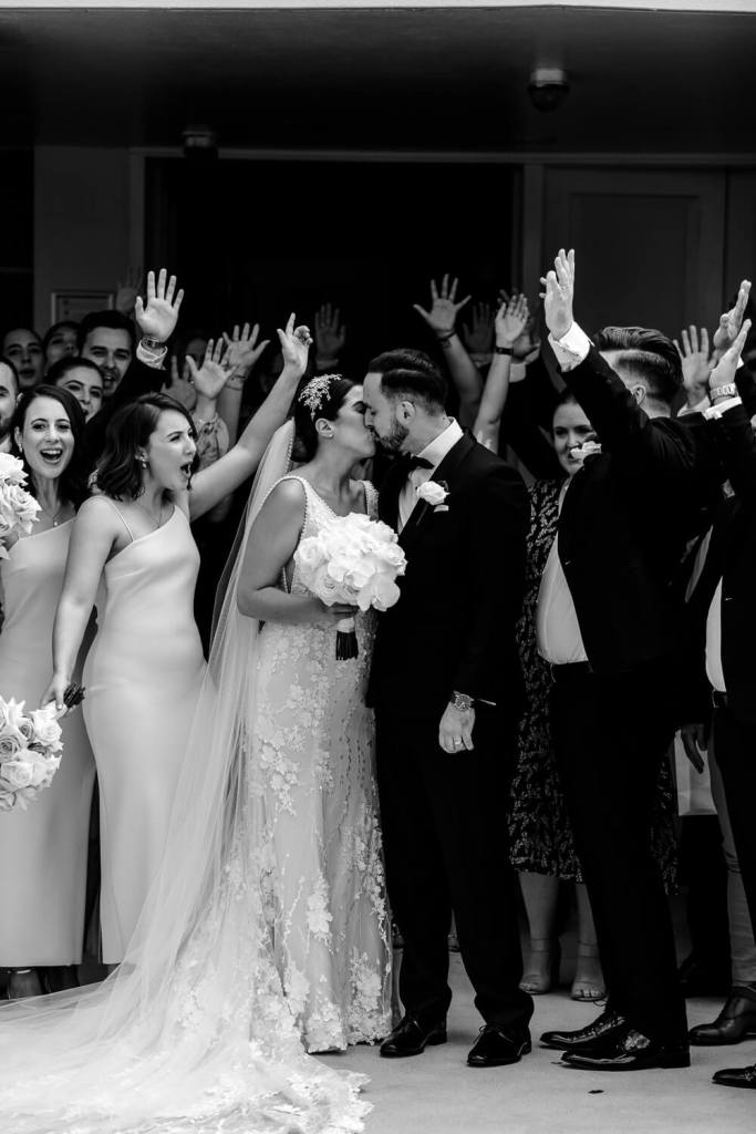 ST-PETER-CHANEL-CATHOLIC-CHURCH-BERALA-SYDNEY-WEDDING-PHOTOGRAPHER-ANELLOWEDDINGS-BRIDE-KISSING-GROUP-PHOTO