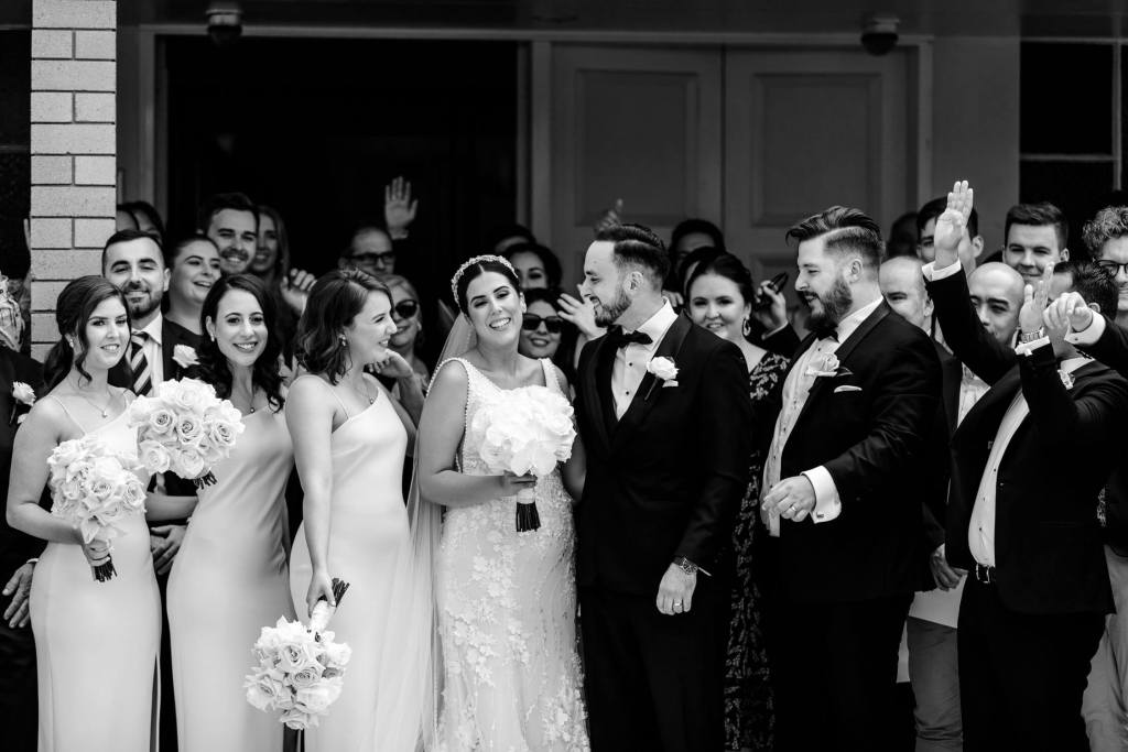 ST-PETER-CHANEL-CATHOLIC-CHURCH-BERALA-SYDNEY-WEDDING-PHOTOGRAPHER-ANELLOWEDDINGS-BRIDE-KISSING-GROUP-PHOTO