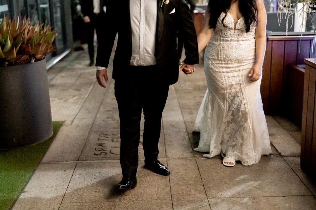 VIEW-BY-SYDNEY-PIER-ONE-WEDDING-PHOTOGRAPHER-ANELLOWEDDINGS-WEDDING-EXITS-COUPLE