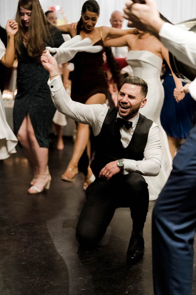 groom smiling and laughing on dancefloor
