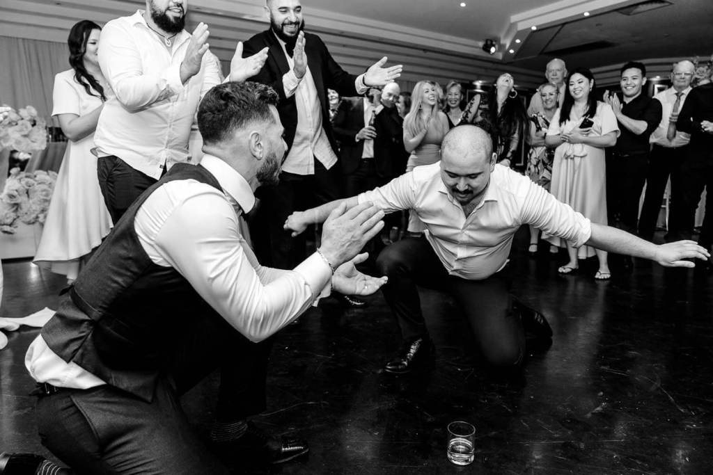 dancing and drinking guests black and white