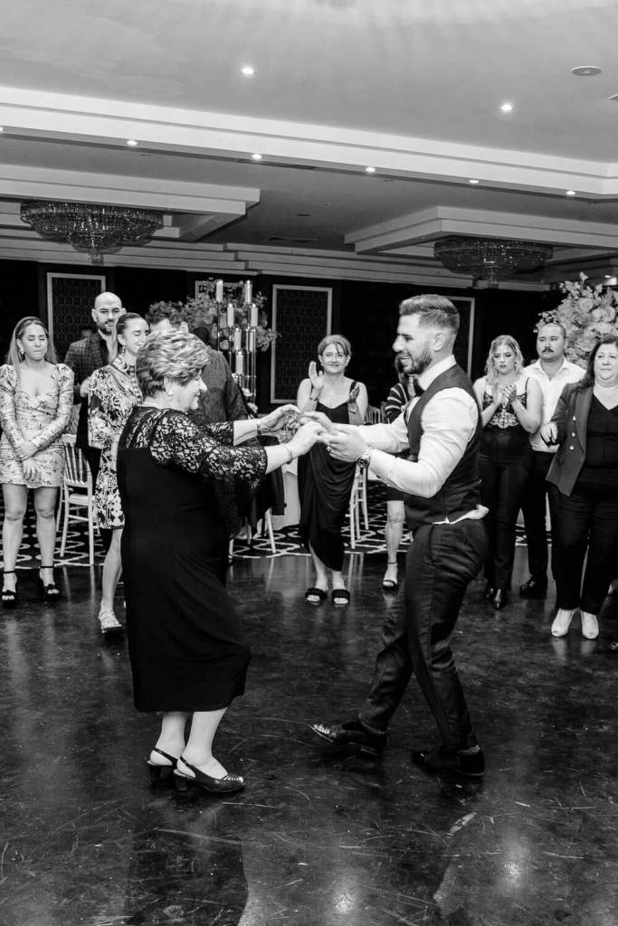 grandma and grandson dancing together black and white