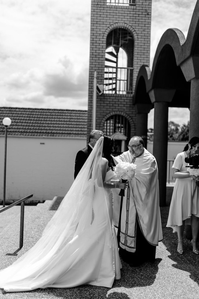 Bride talking with priest