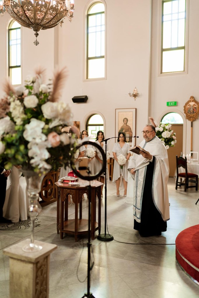 priest giving a prey at church