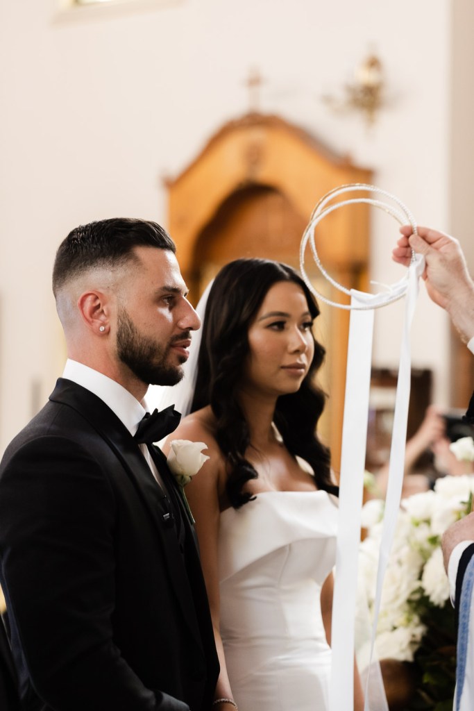 bride and groom have crowns at their heads
