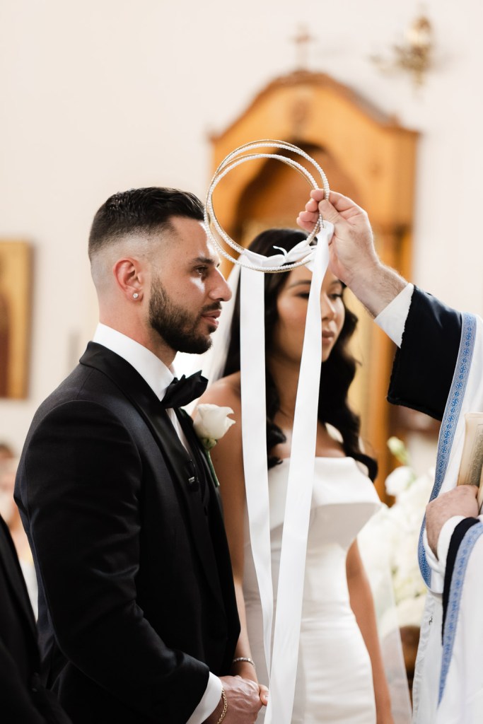 bride and groom have crowns at their heads
