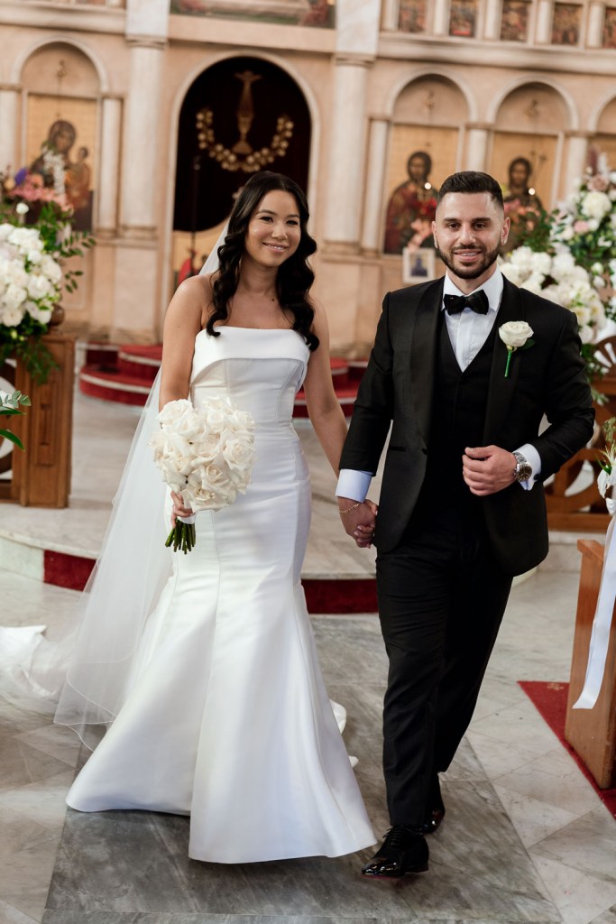 bride and groom smiling inside church