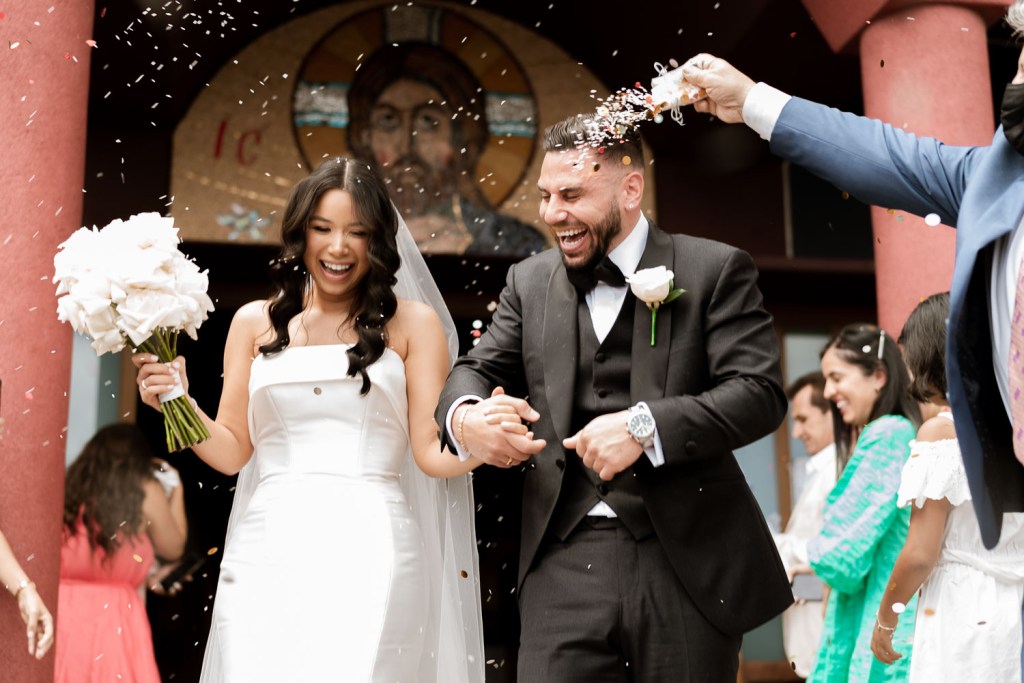 bride and groom exiting church with confetti throw