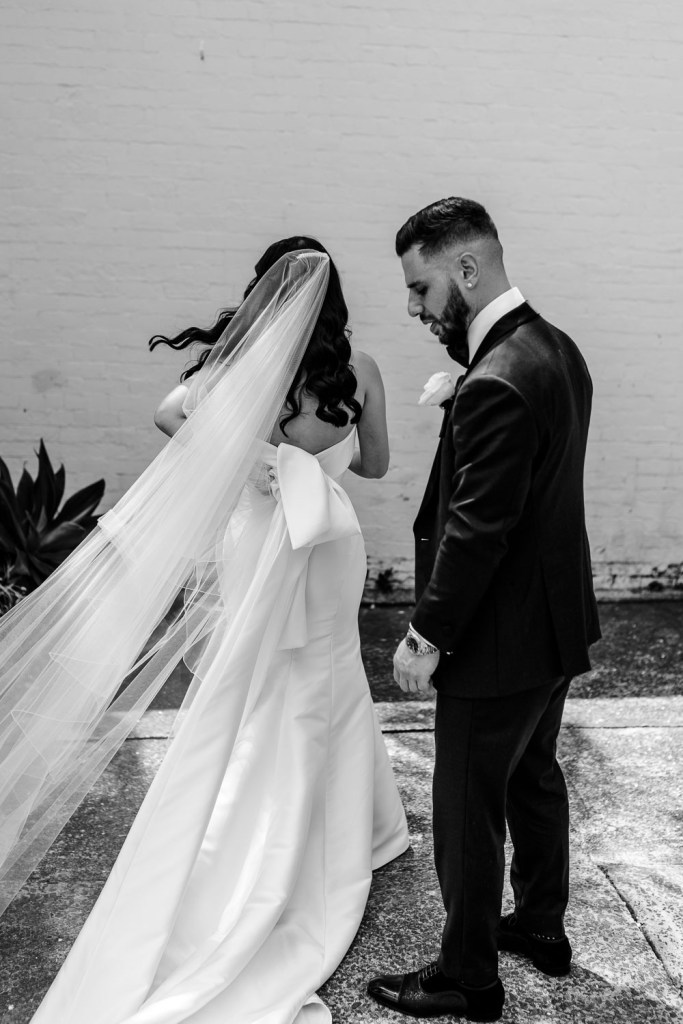 brides and groom in wind near steps