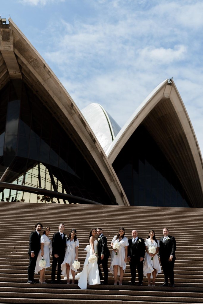bridal party walking down of opera house stairs