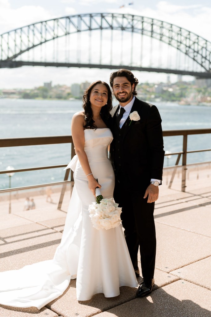 bride smiling with groomsman in city