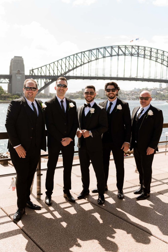 groomsman smiling infront of harbour bridge