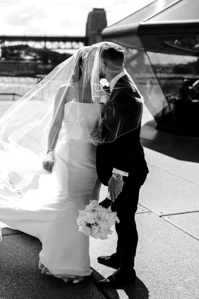 bride and groom in viel together black and white