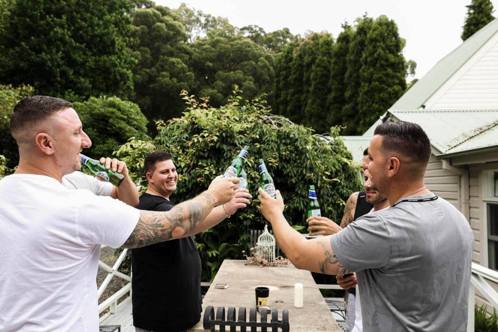 Groom and groomsmen drinking