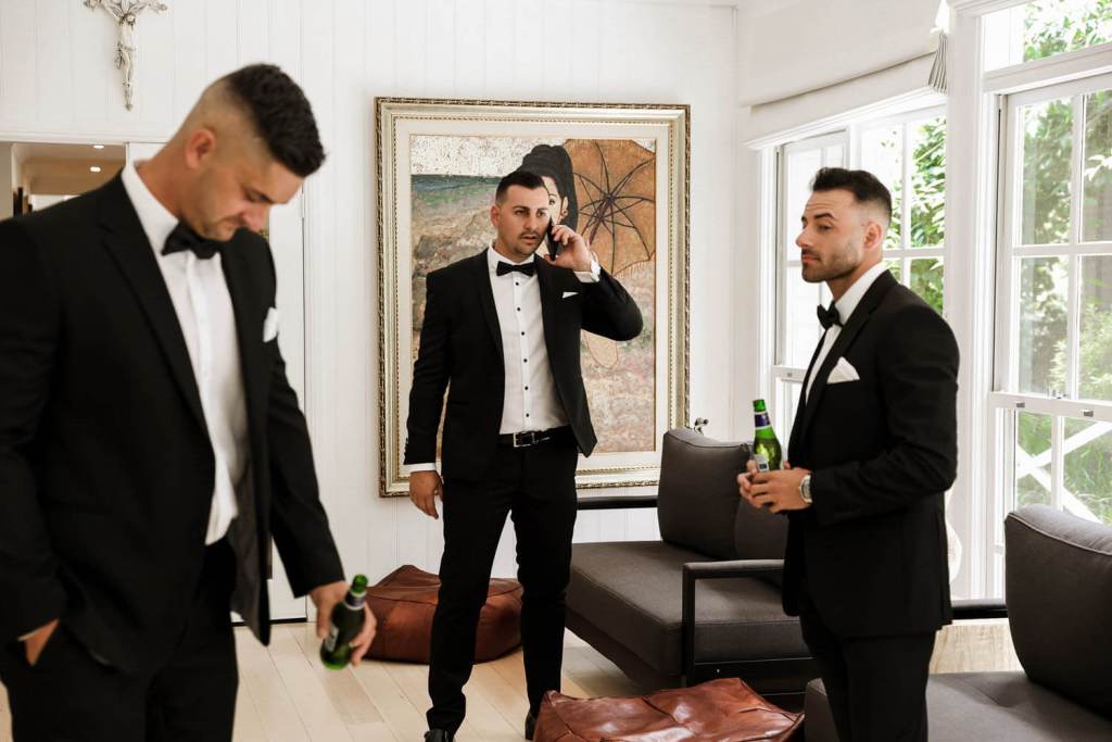 Groomsmen drinking at grooms