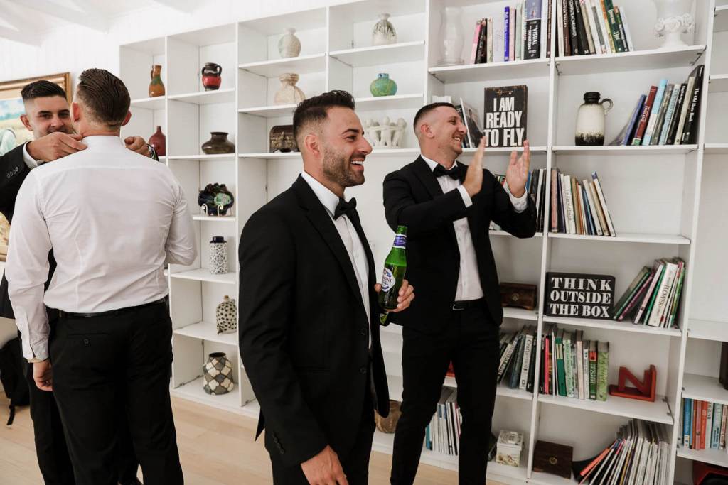 Groomsmen drinking at grooms