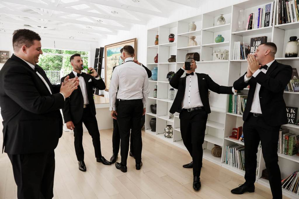 Groomsmen drinking at grooms