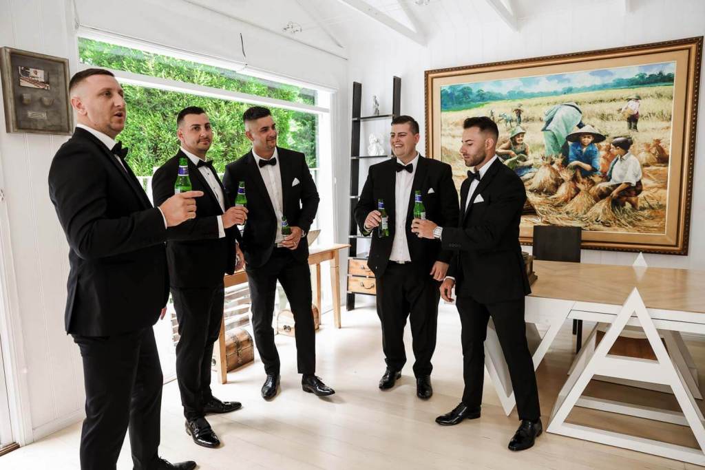 Groomsmen drinking at grooms