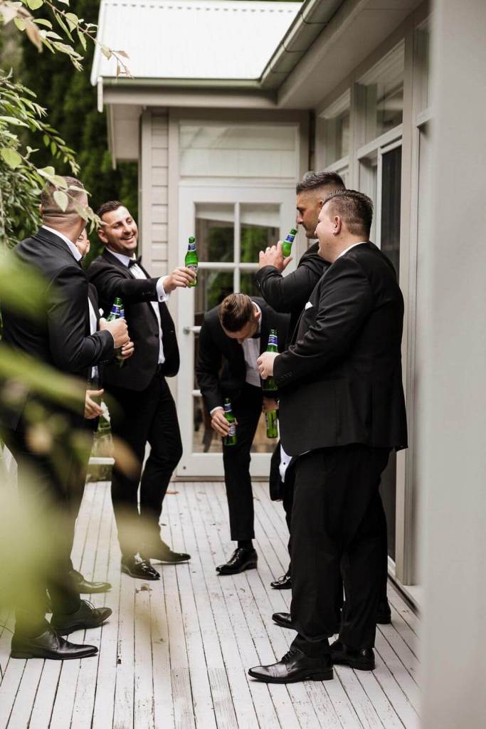 Groomsmen drinking at grooms