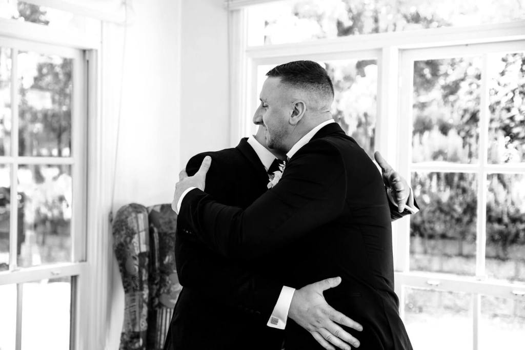 Putting flower on groom