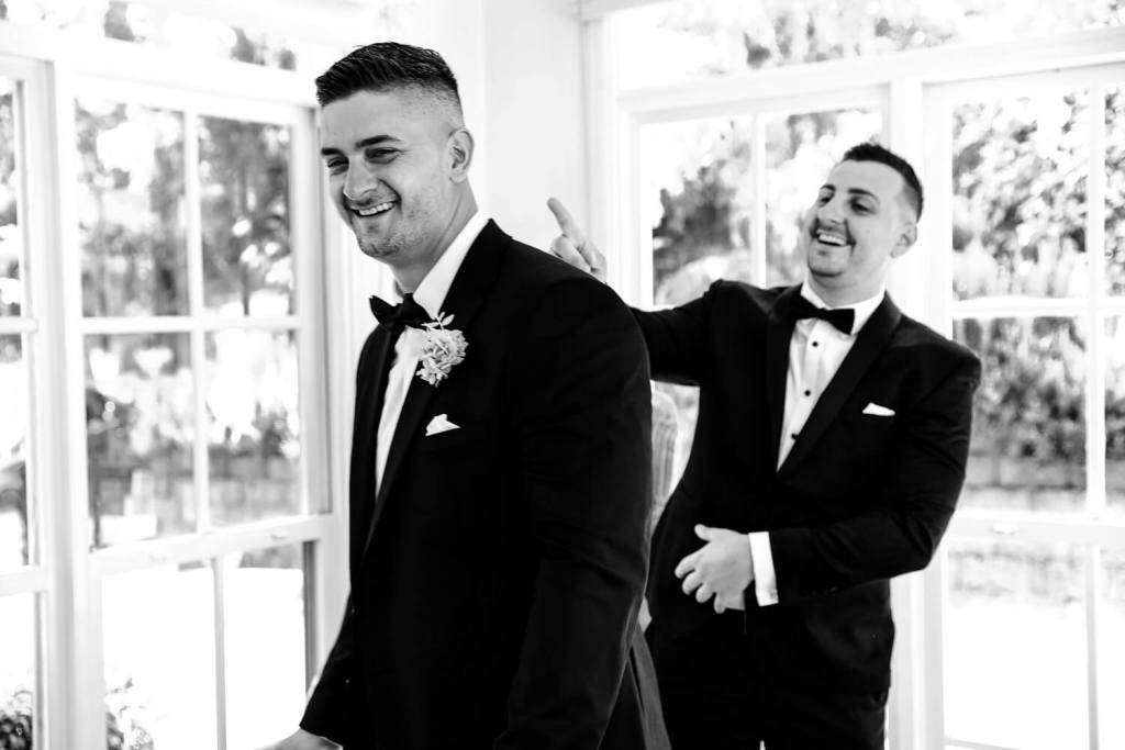 Putting flower on groom