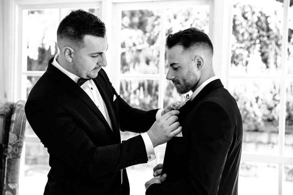 Putting flower on groom