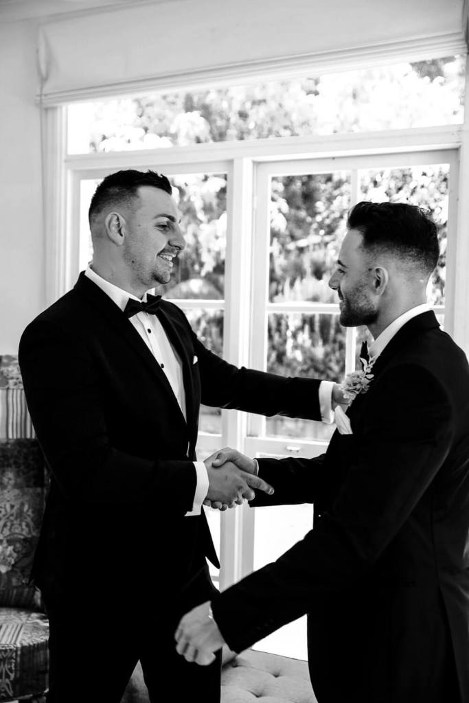 Putting flower on groom