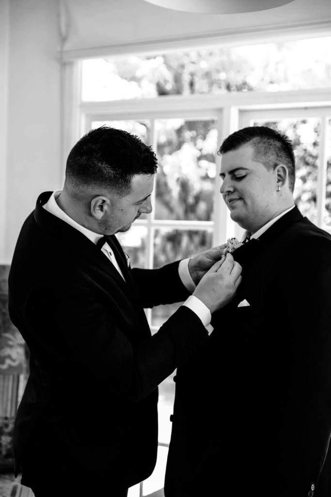 Putting flower on groom