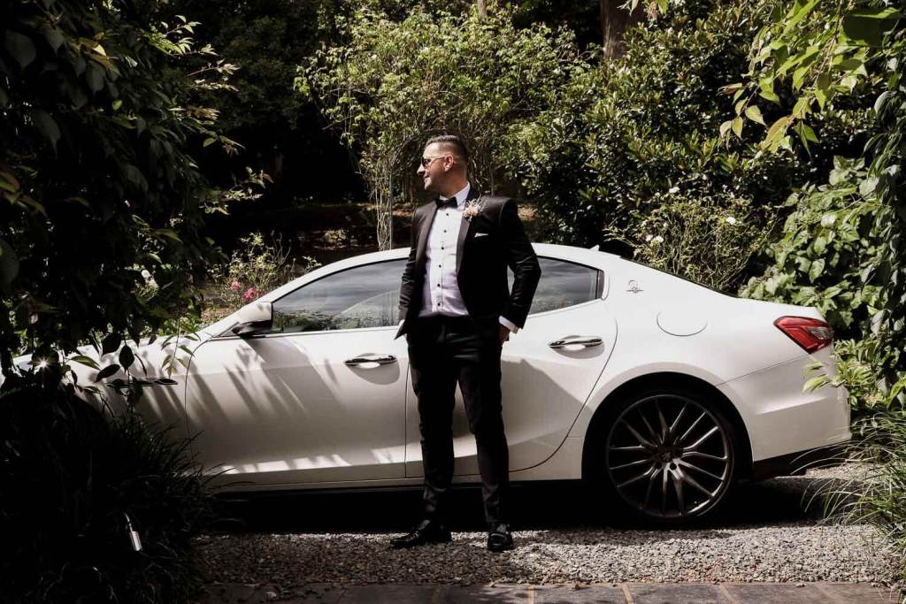 Groom in front of car