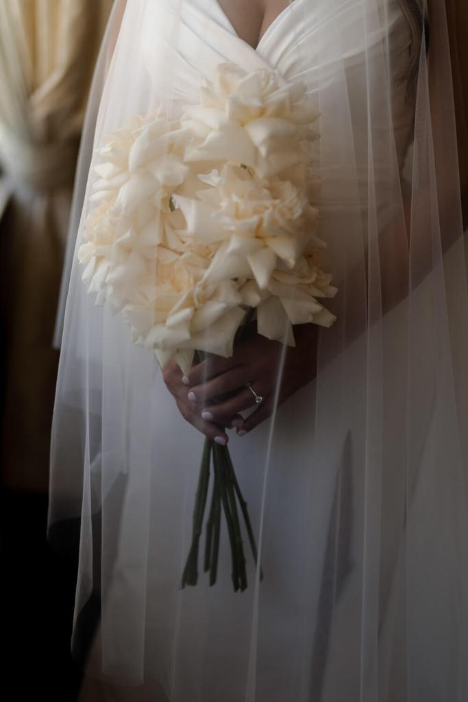 Bride in Yulia McCauley Wedding Dress holding flowers