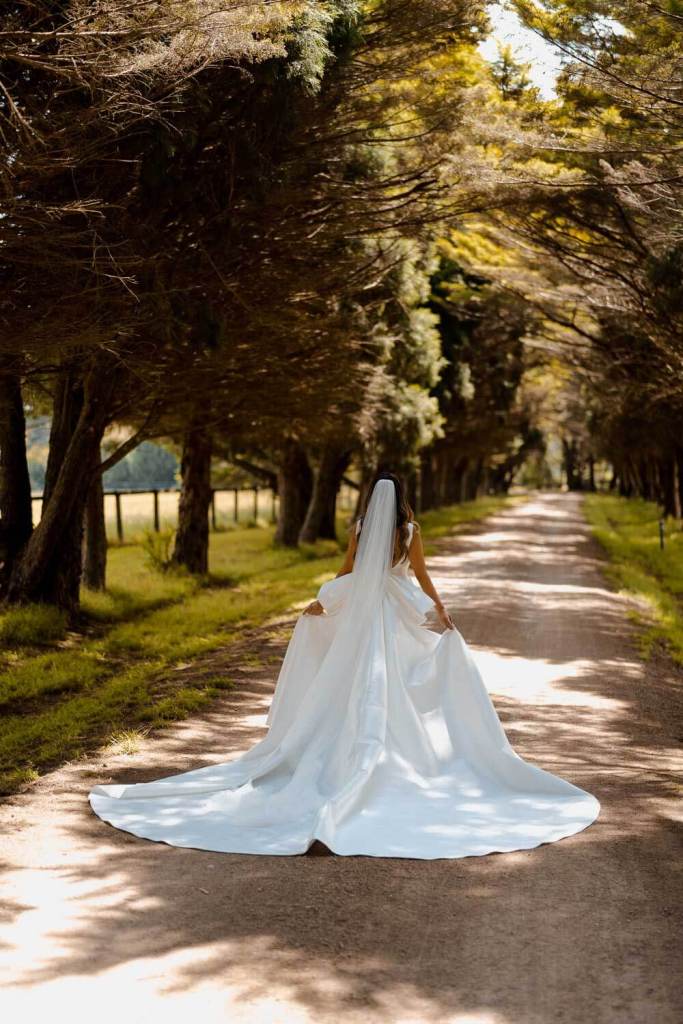 Bride in Yulia McCauley Wedding Dress between trees
