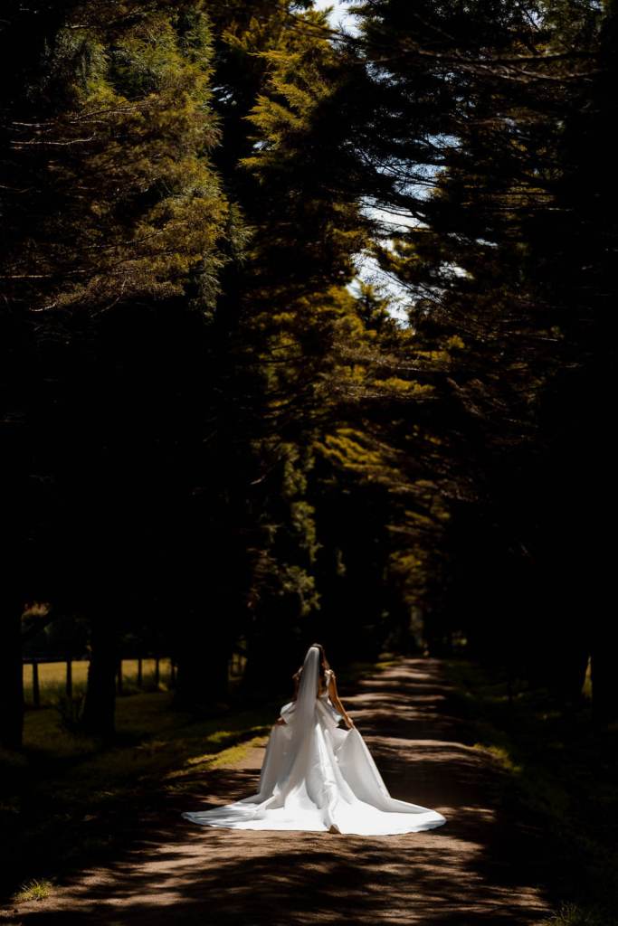 Bride in Yulia McCauley Wedding Dress between trees