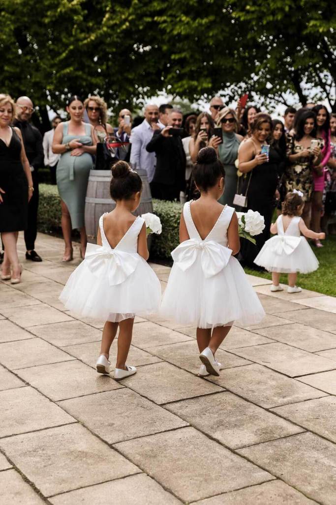 Flower girl dresses walking down aisle