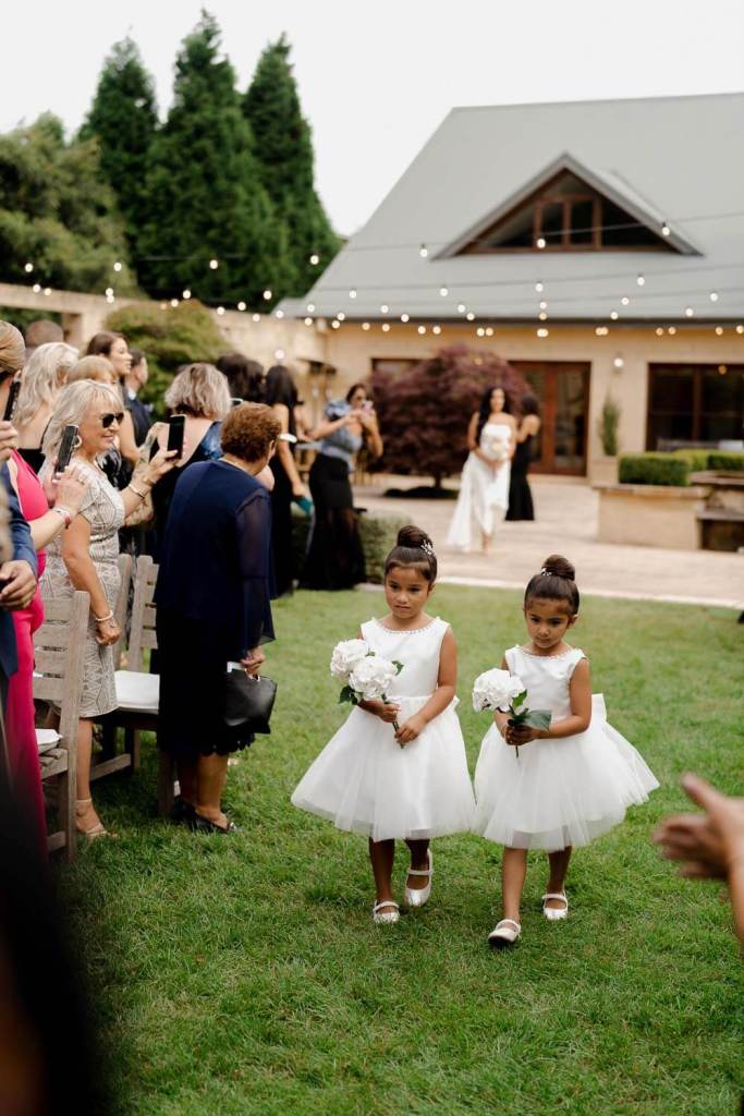 Flower girl dresses walking down aisle
