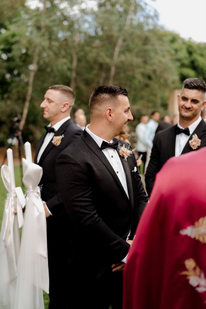 Groom smiling at bride