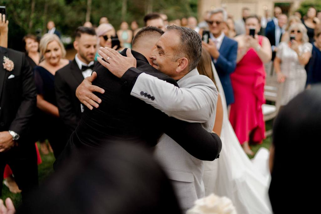 Groom and dad hugging