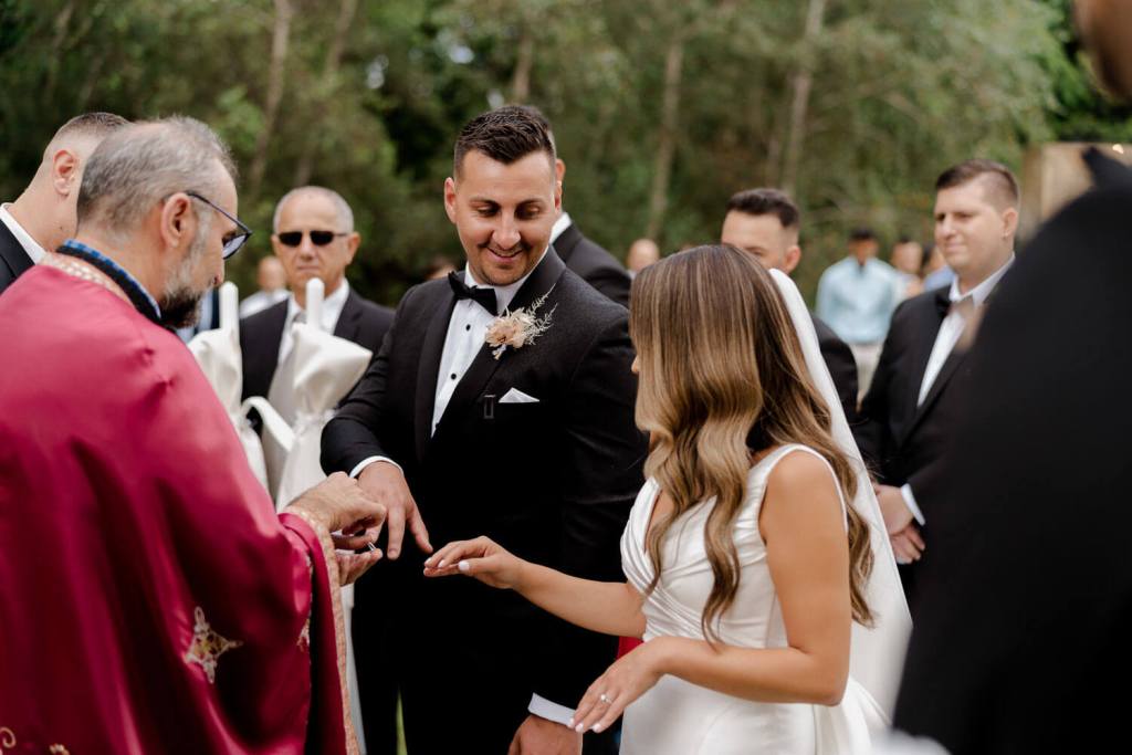 Bride and groom exchanging rings