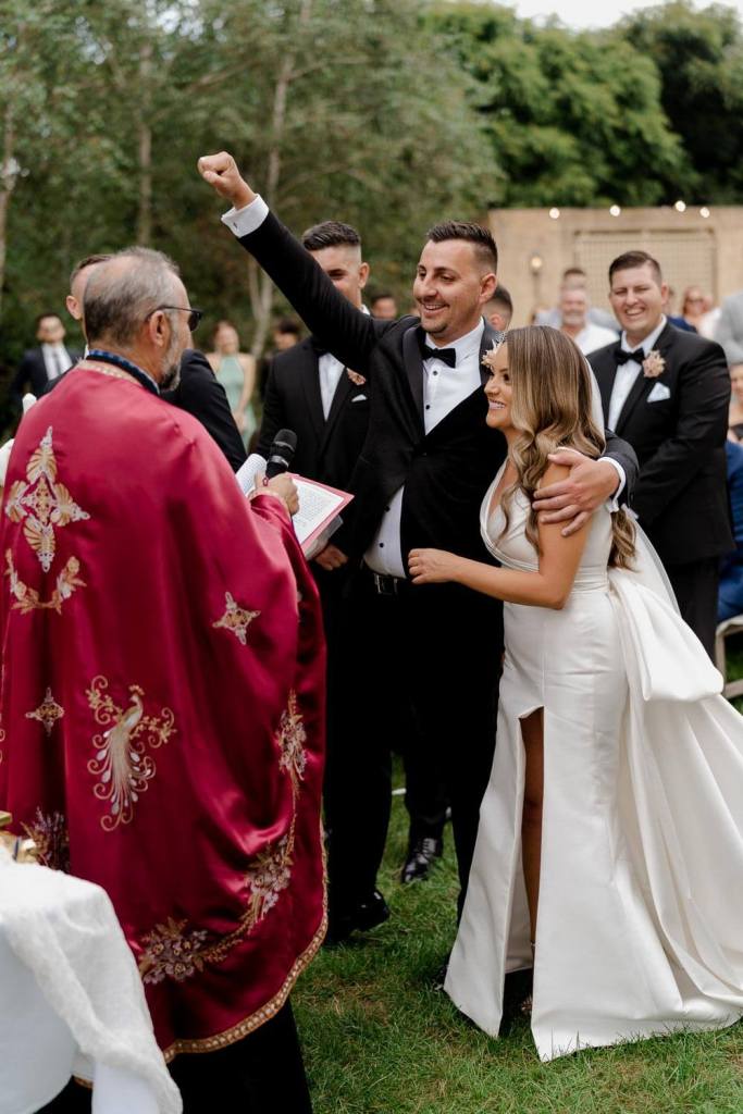 Groom cheering with bride
