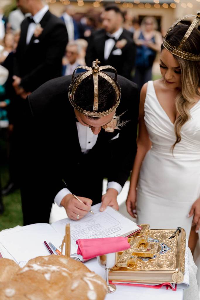 Groom signing marriage certificate