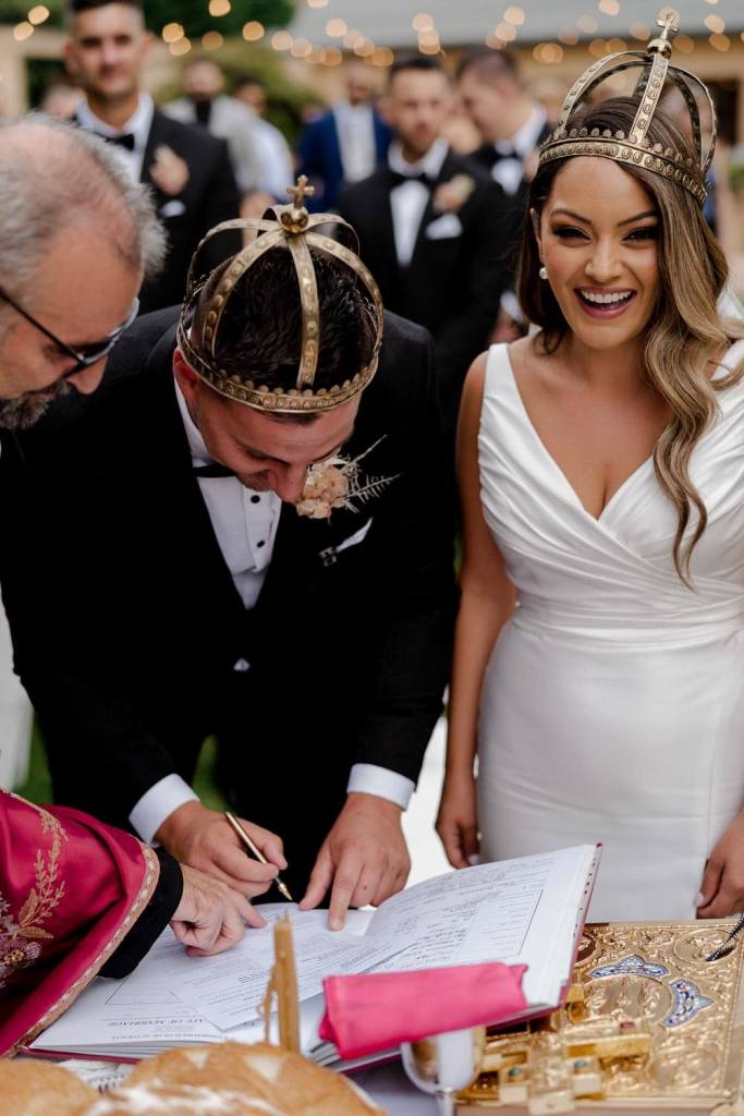 Groom signing marriage certificate