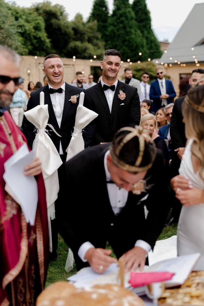 Groom signing marriage certificate