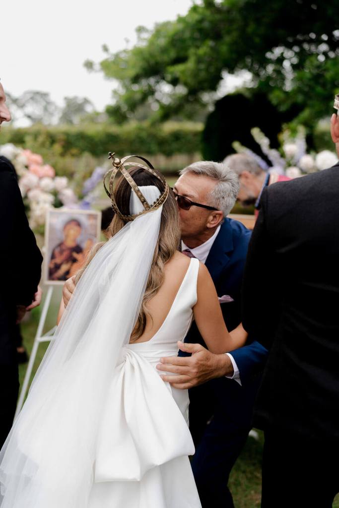 Guests kissing bride