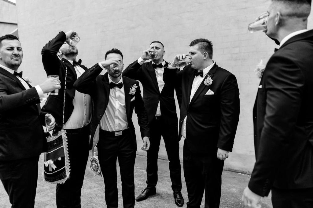 Groomsman drinking shots