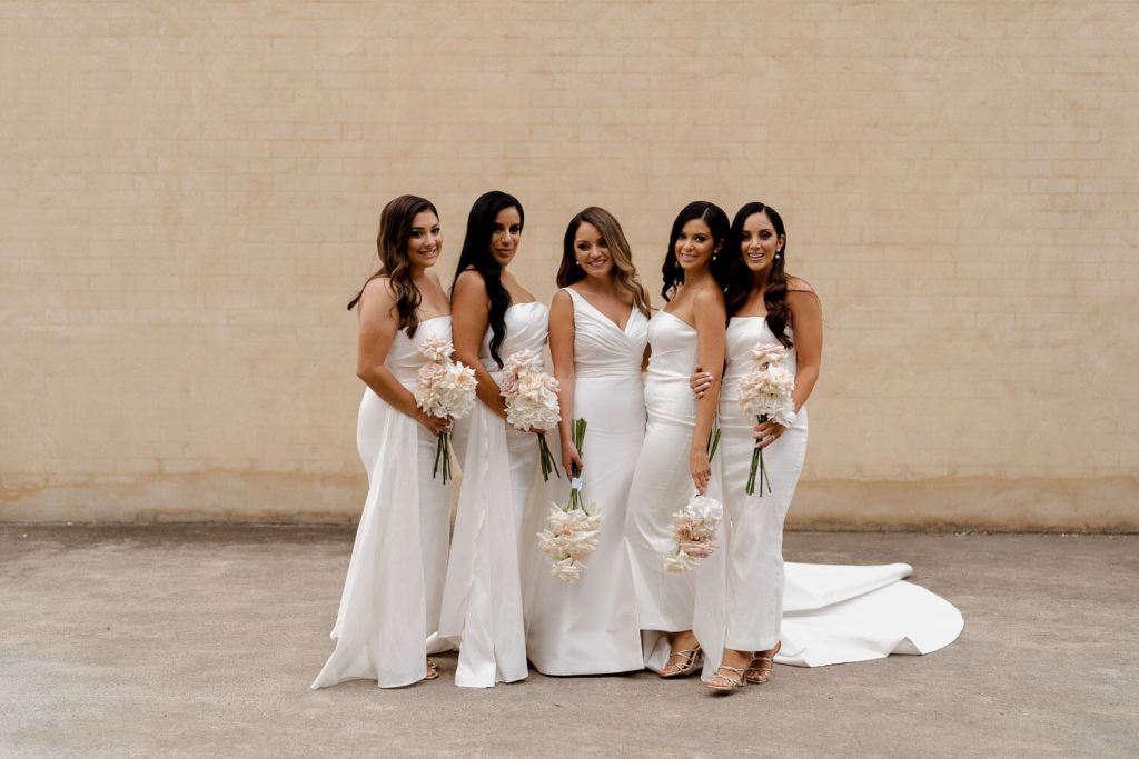 Bridesmaids and bride smiling