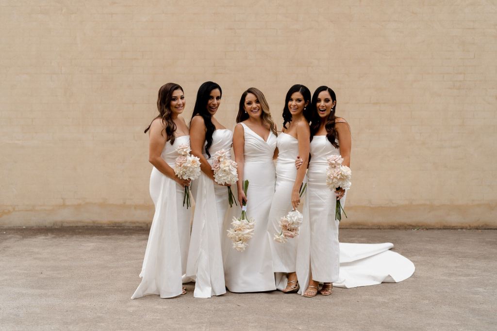 Bridesmaids and bride smiling