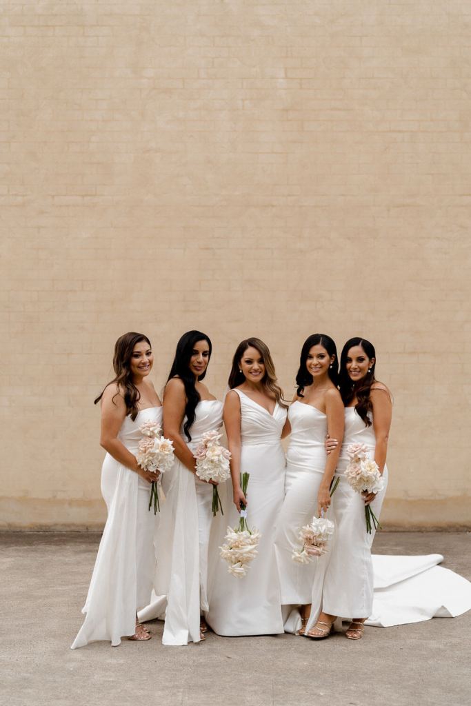 Bridesmaids and bride smiling
