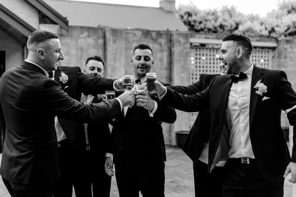 Groomsman cheersing drinks